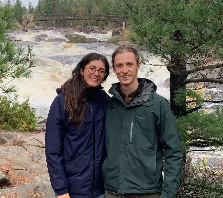 Blair and Liz of Nord, in front of a Northern Ontario river