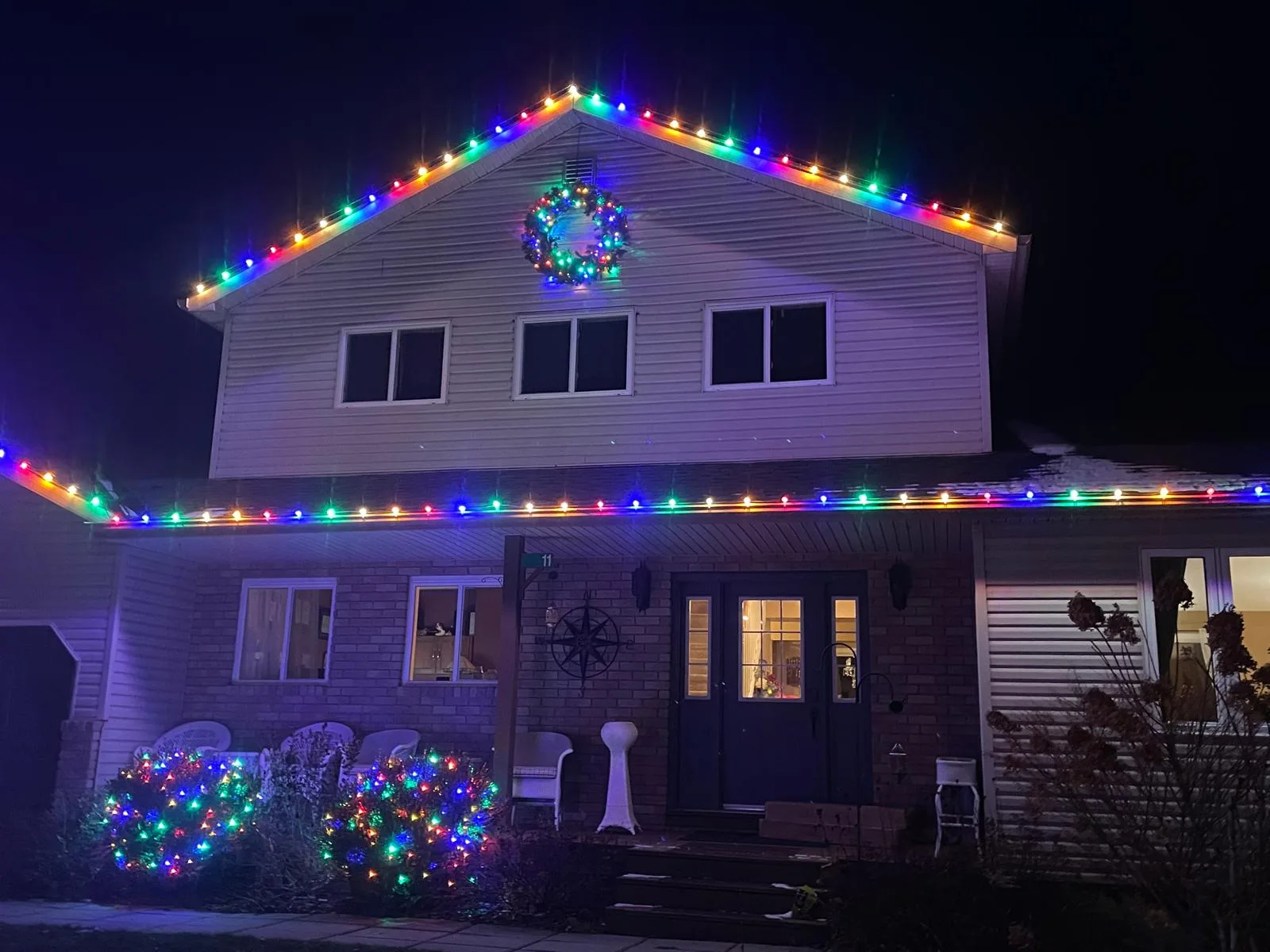 Professional Christmas light installation — Full multi-colour · roofline, wreath & garden beds